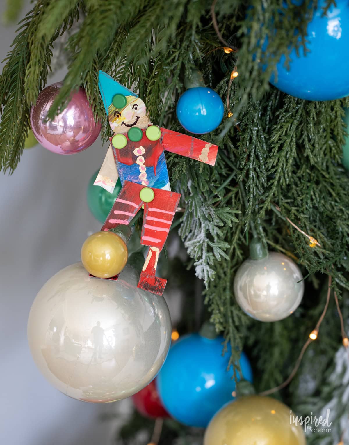 small figure made from colorful painted papers. 