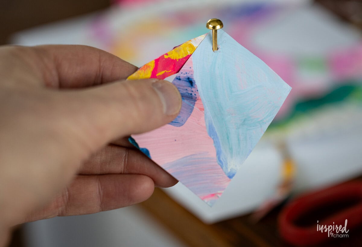 adding fastener to paper.