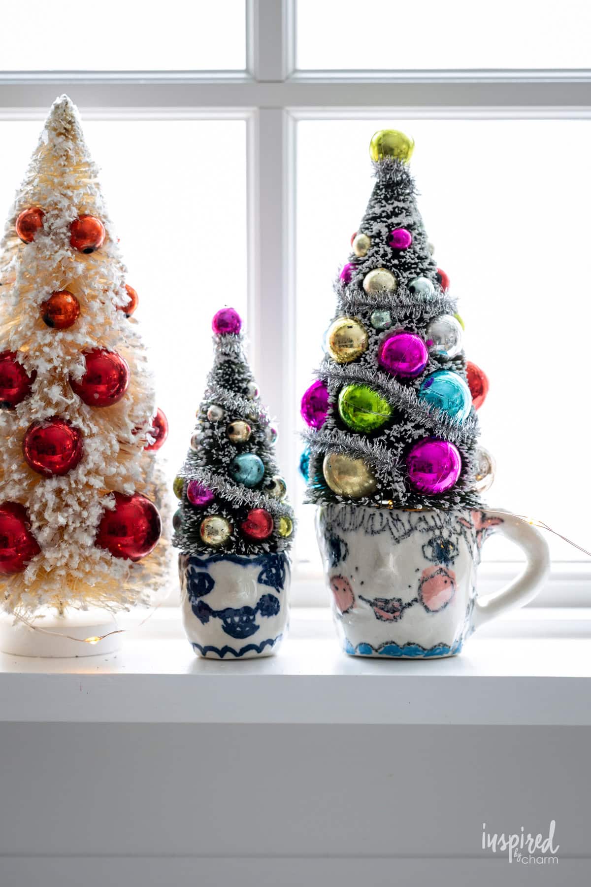 small pottery cups with bottle brush trees.