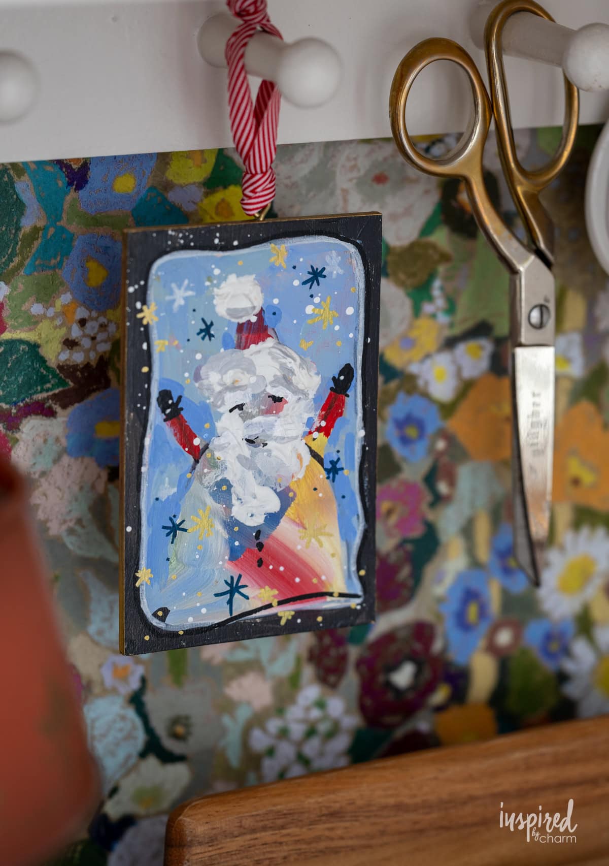 santa painting hung on a peg. 