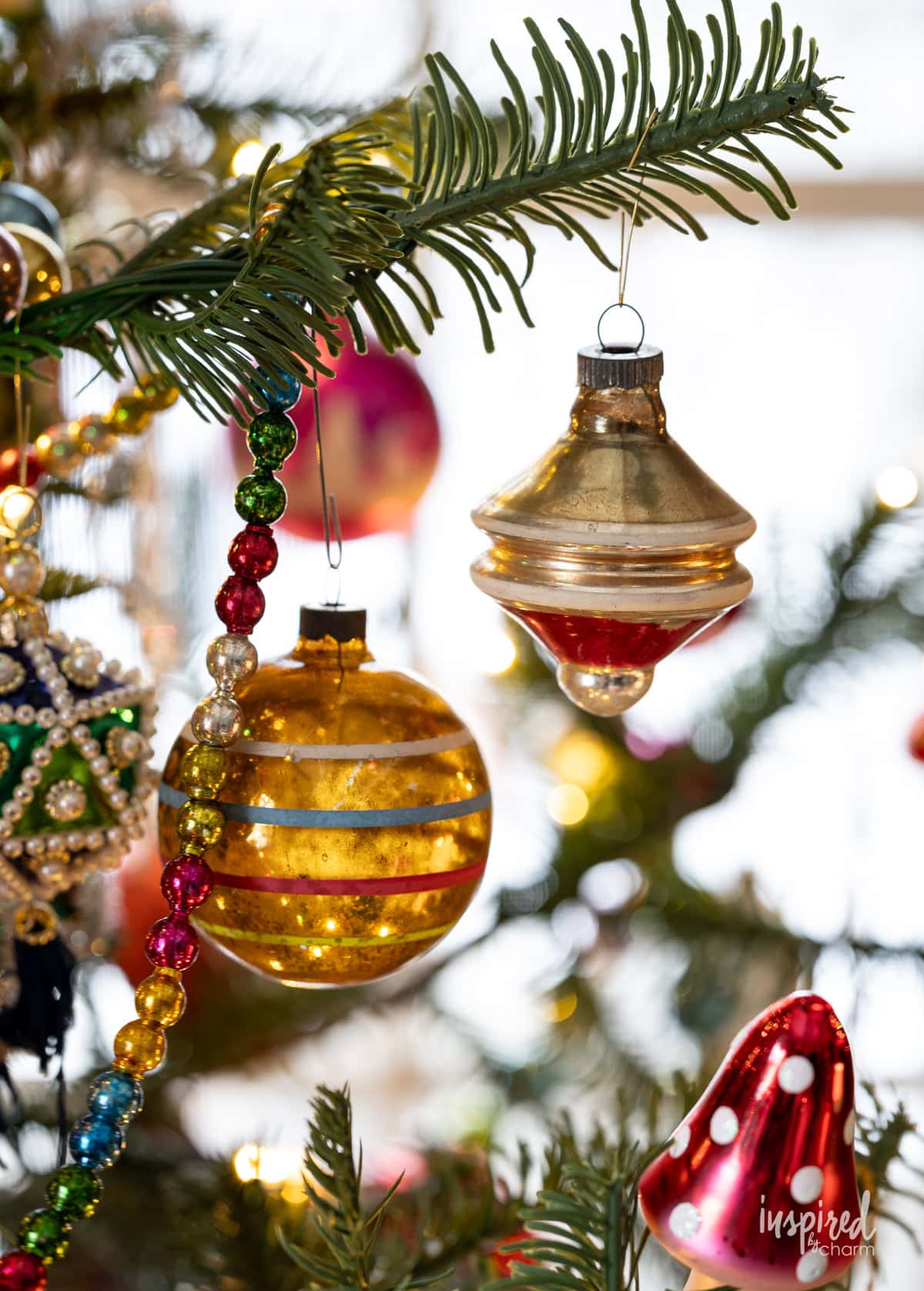 vintage ornaments hung on a christmas tree.