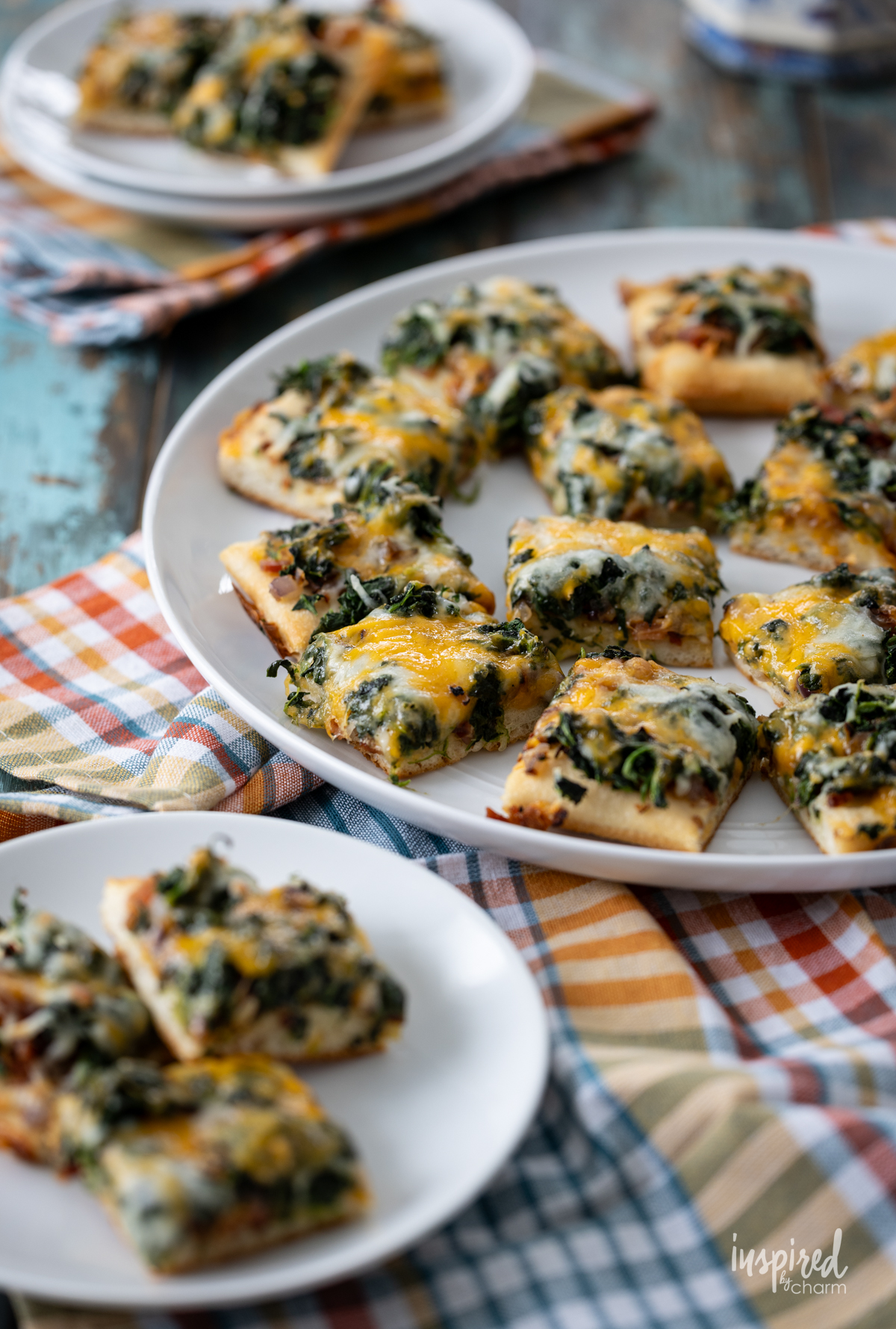 Cheesy Spinach Bacon Appetizer Bars served on a platter and plates.