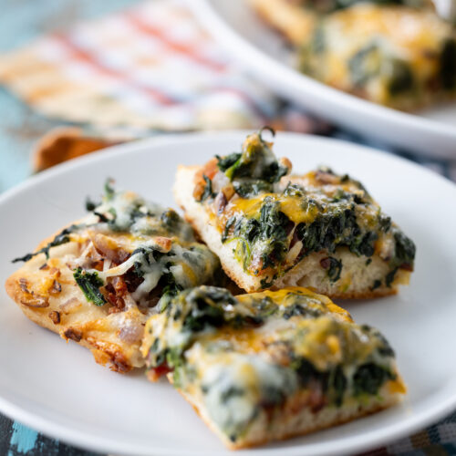 Cheesy Spinach Bacon Appetizer Bars served on a plate.