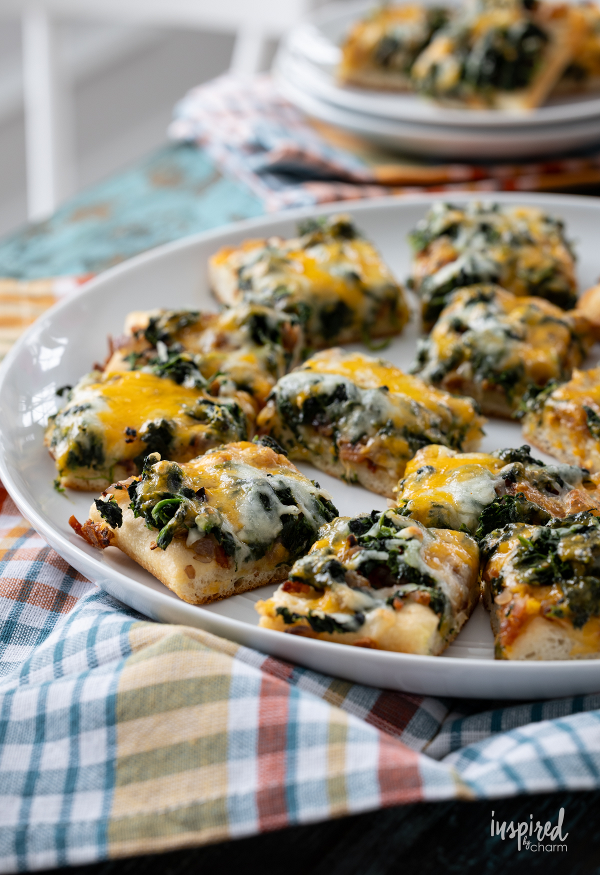 Cheesy Spinach Bacon Appetizer Bars serving a a table.