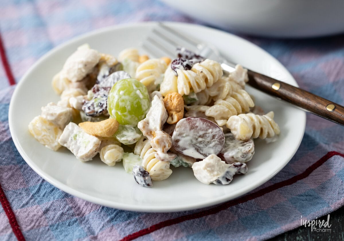 serving of Chicken and Cashew Pasta Salad on a plate with a fork.