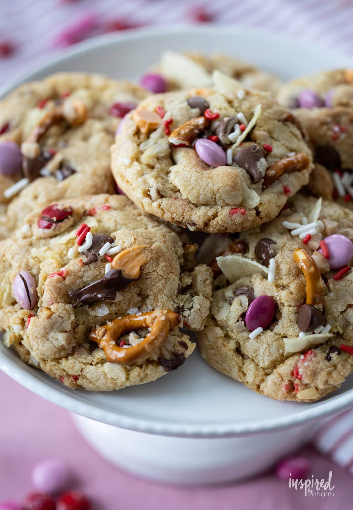 array of Kitchen Sink Cookies for Valentine’s Day on a cake stand.