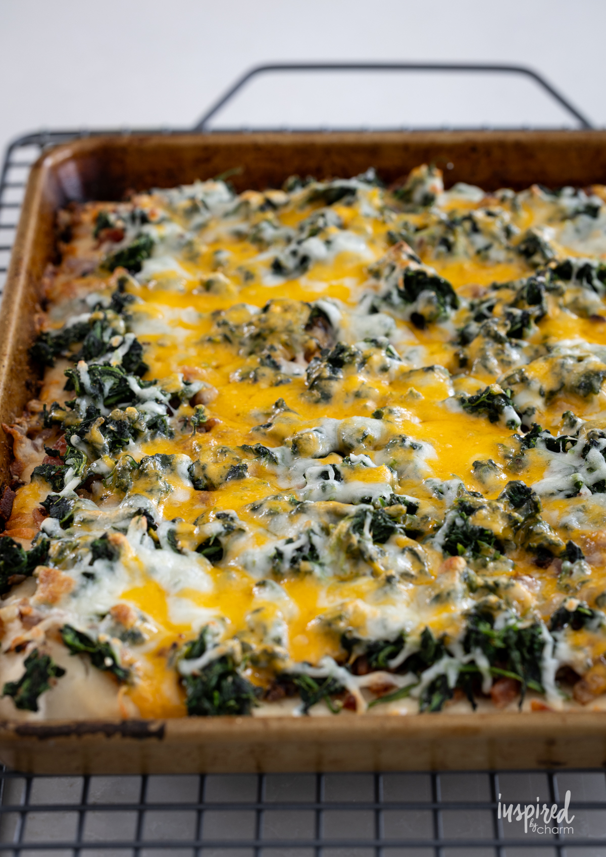 baked Cheesy Spinach Bacon Appetizer Bars in a sheet pan.