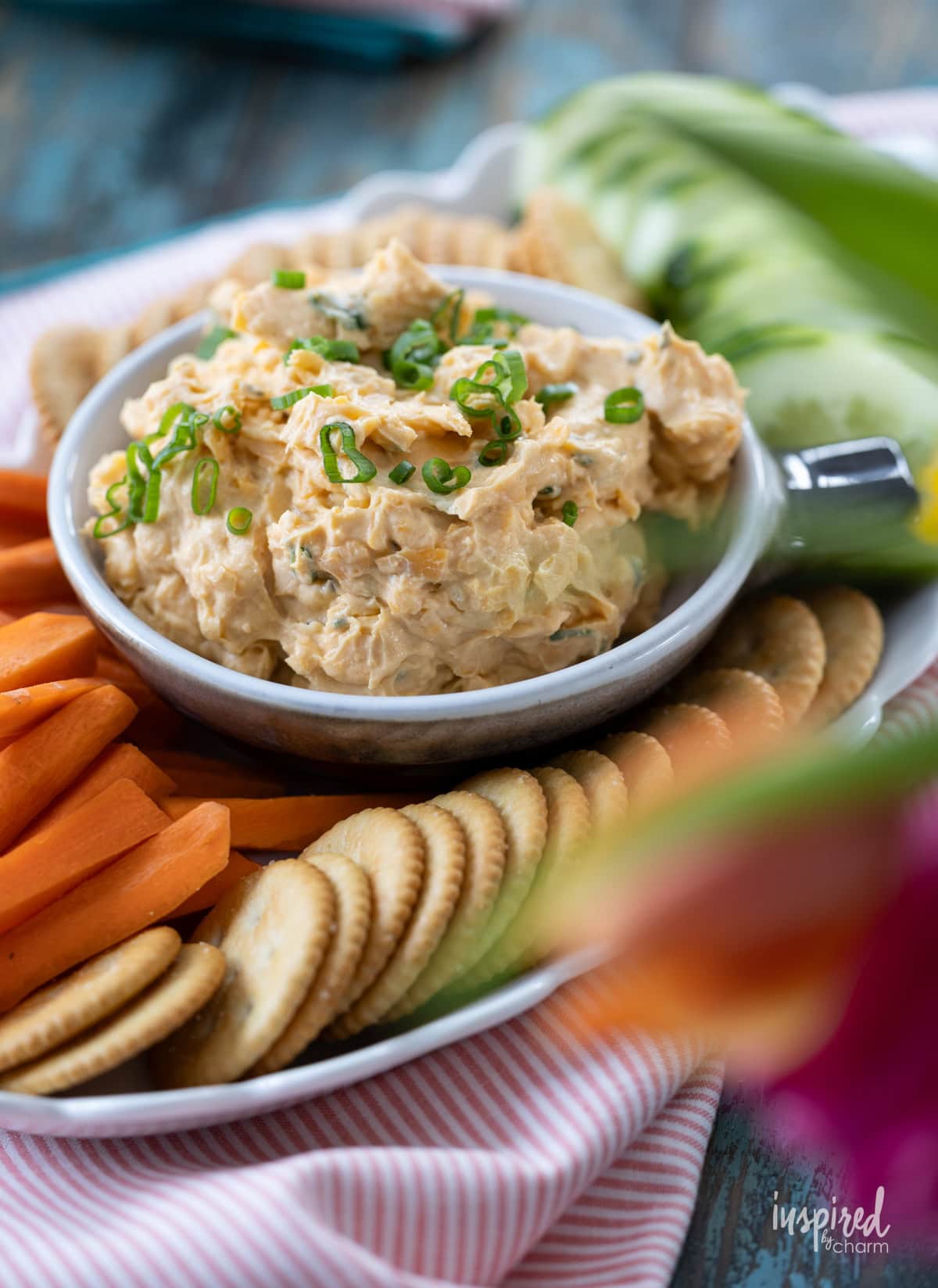 Bowl filled with Pub-Style Cheddar Cheese Dip and served with crackers.