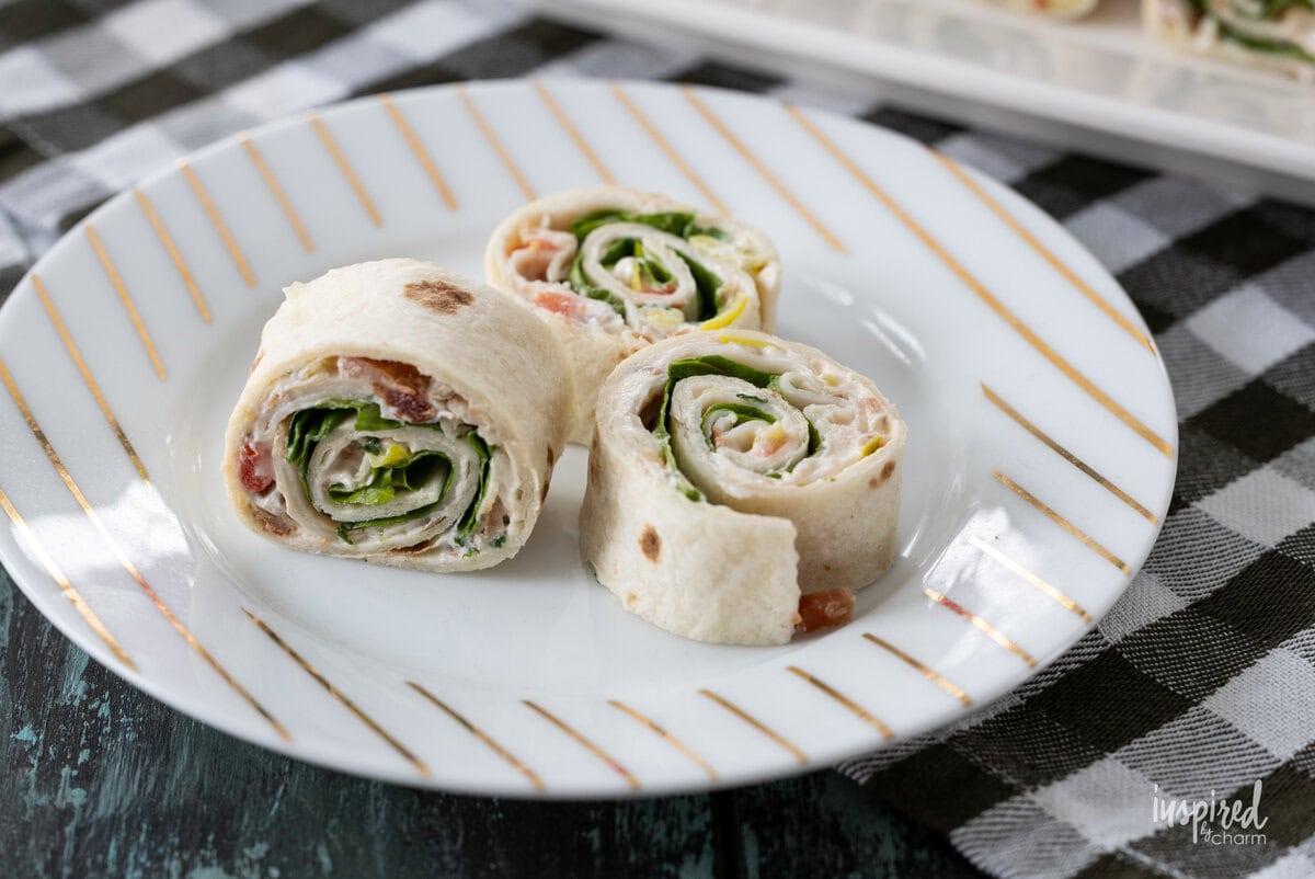 small plate with three Turkey Club Sandwich Roll-Ups.