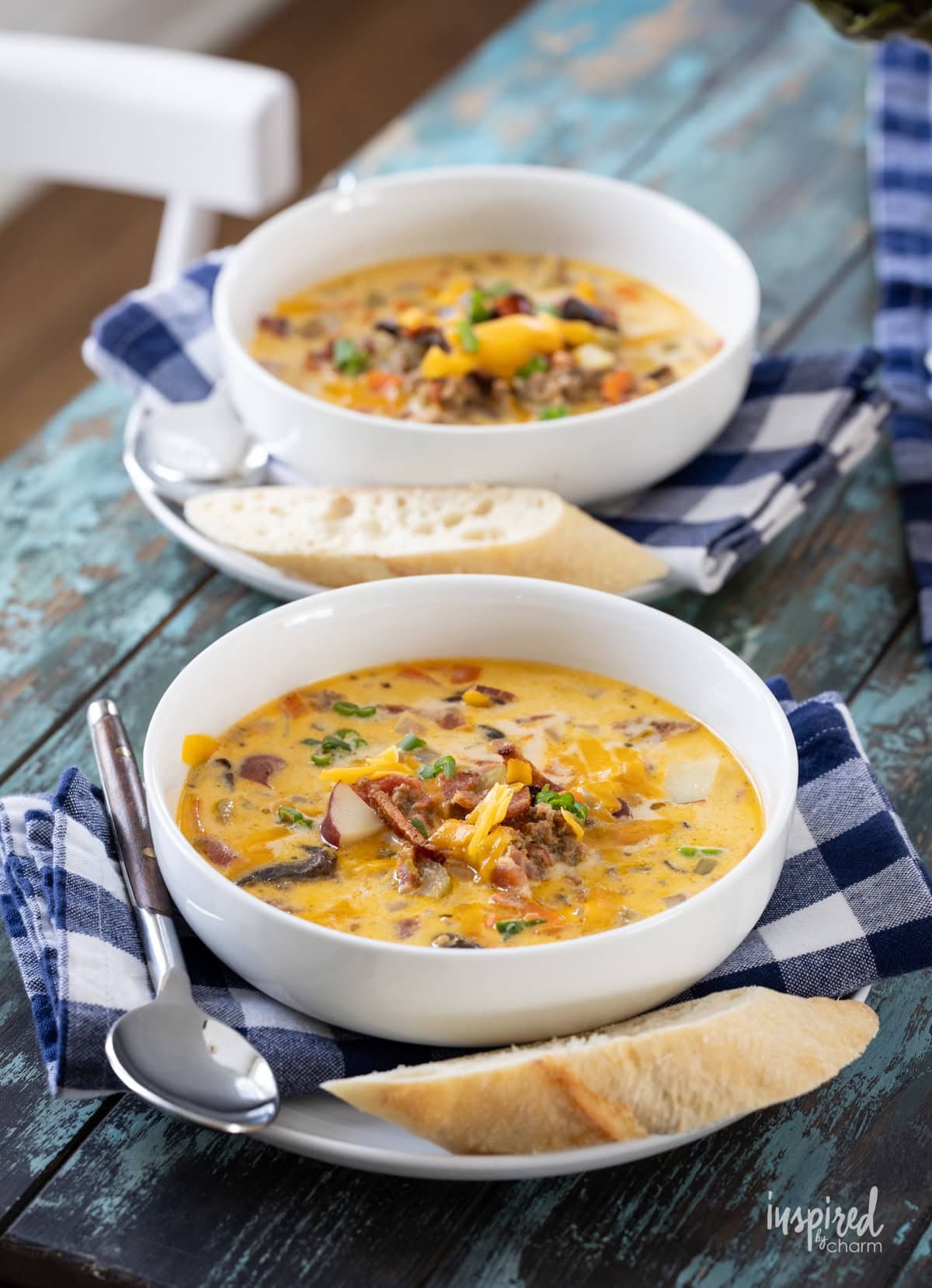 two bowls of cheeseburger soup  on a table. 