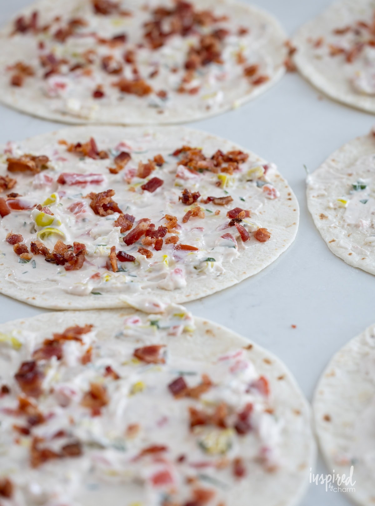 tortilla with cheese spread on them. 