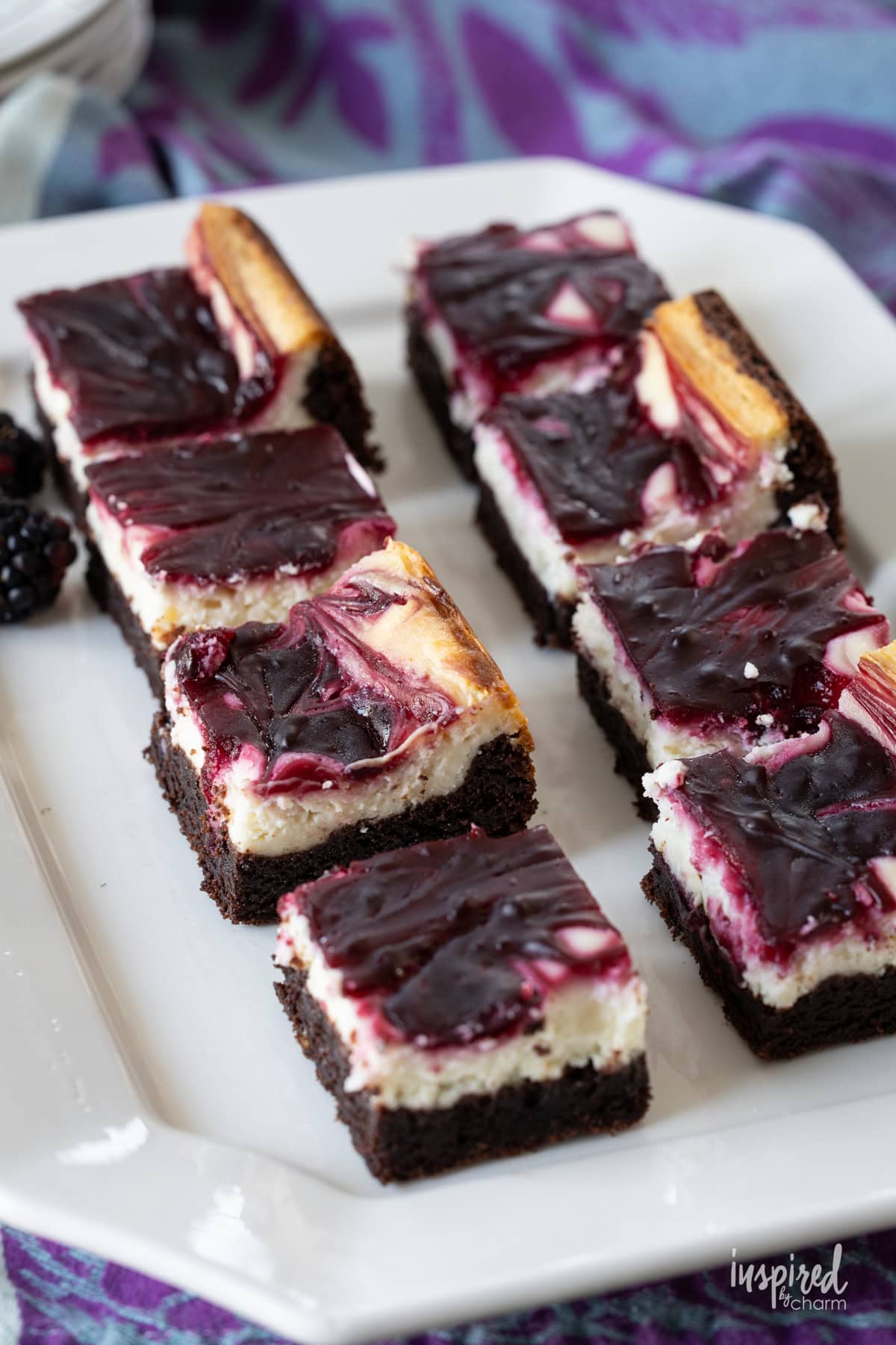 Blackberry Cheesecake Brownies on a white plate.