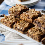 Chocolate Chip Caramel Cookie Bars stacked on a platter.