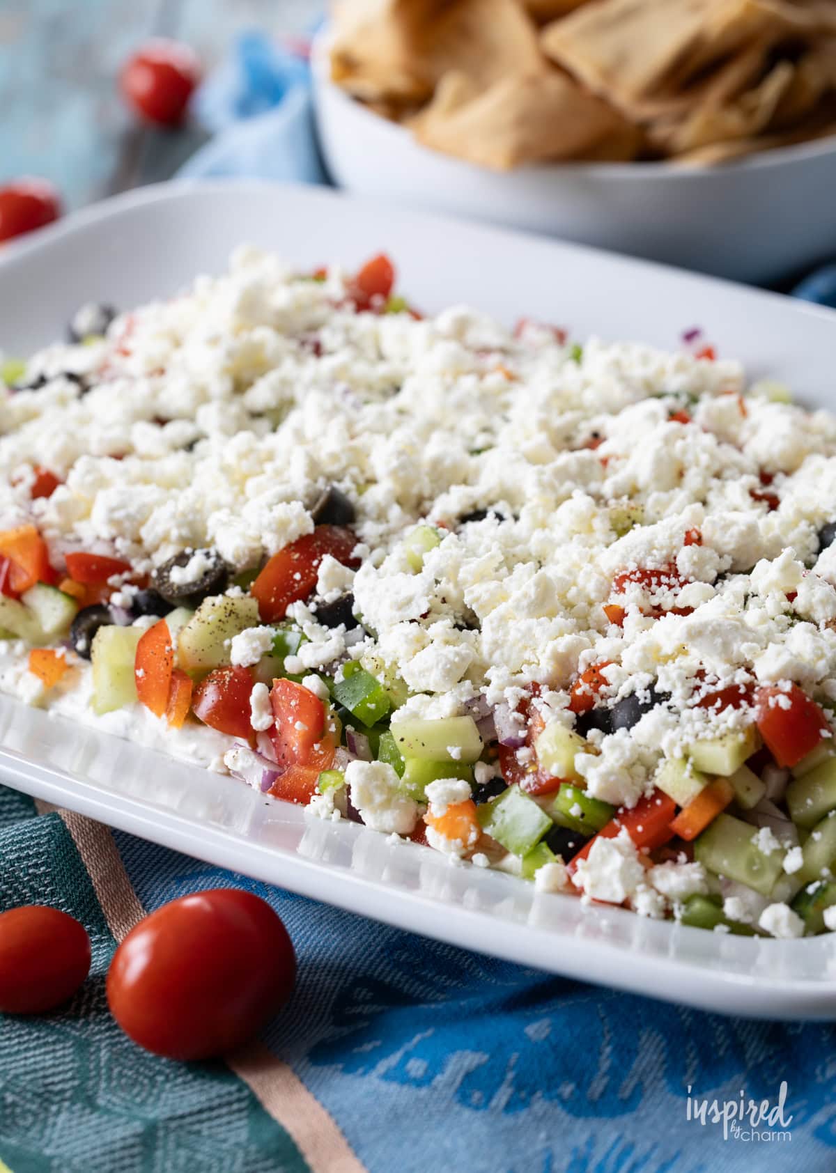 large white platter filled with greek feta layer dip.