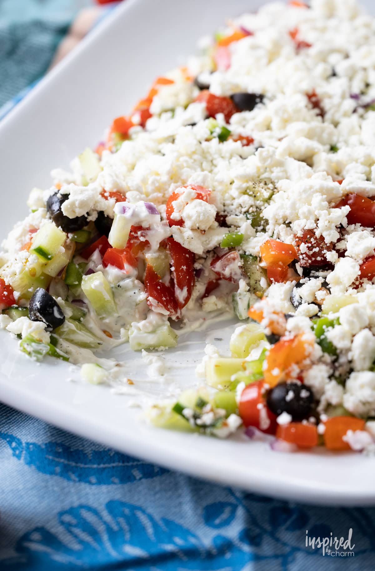 greek feta layer dip with a bit removed.