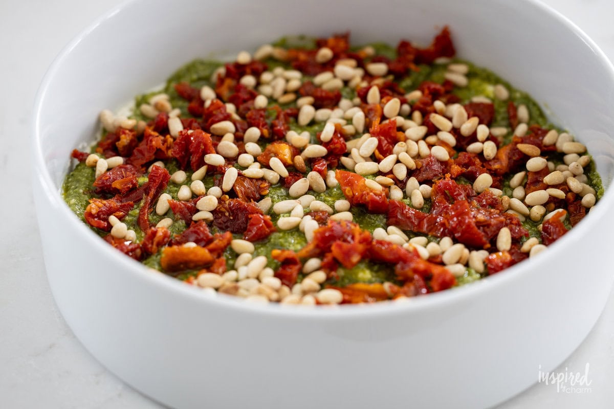 making Pesto and Feta Layer Dip in a bowl.
