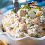 bowl filled with Neiman Marcus Dip served with crackers.