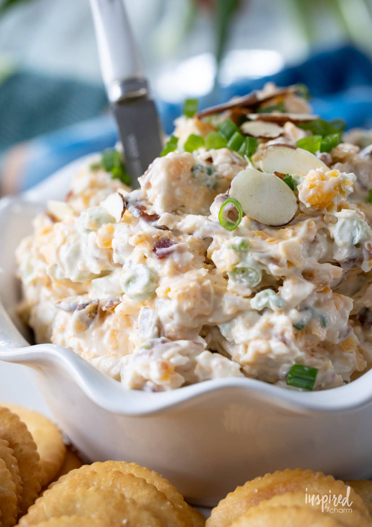 bowl filled with Neiman Marcus Dip served with crackers.