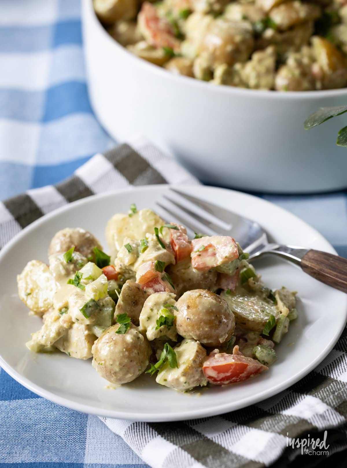 Pesto Chicken Potato Salad served on a small plate with a fork. 