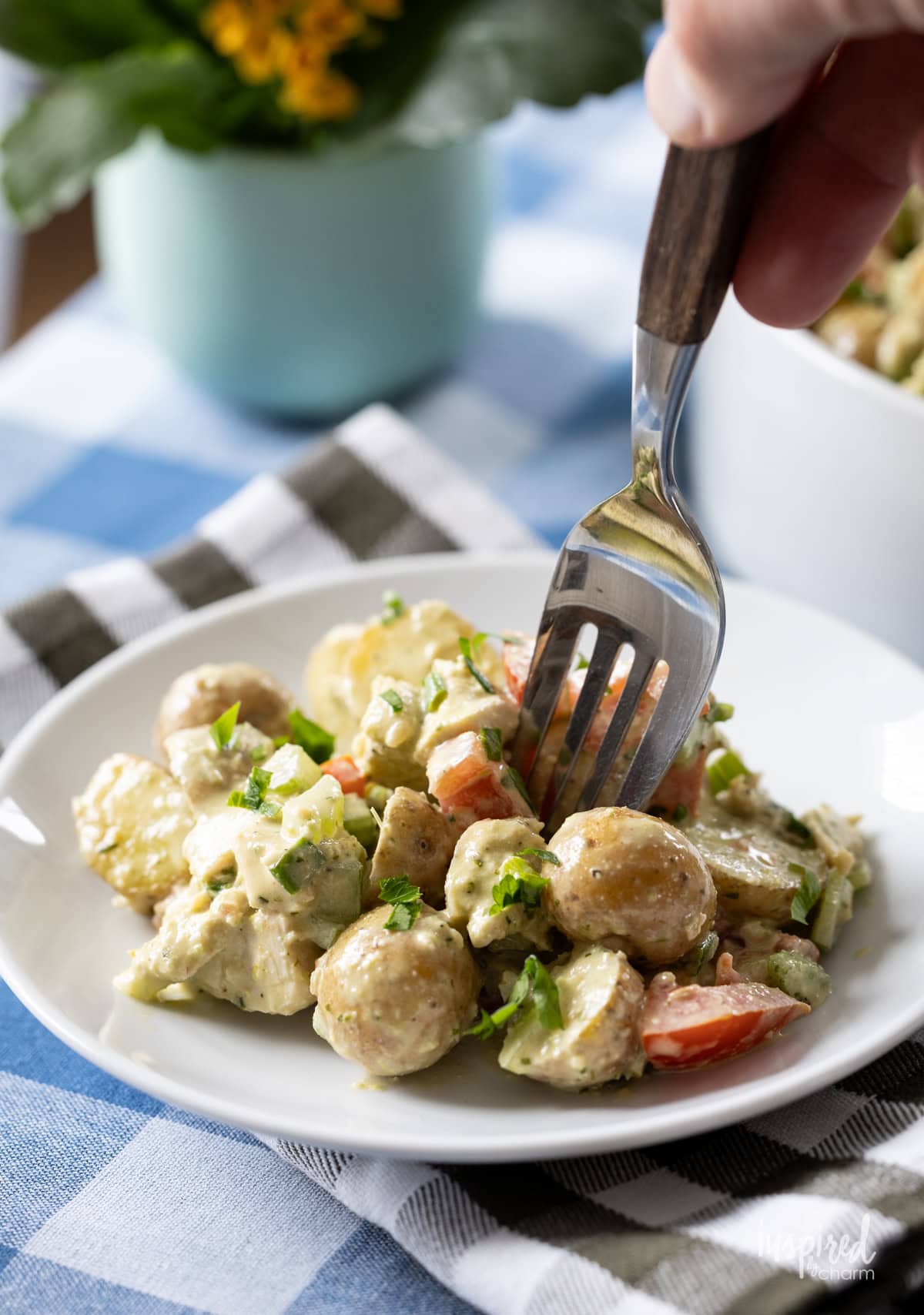 Pesto Chicken Potato Salad on a plate with a fork. 