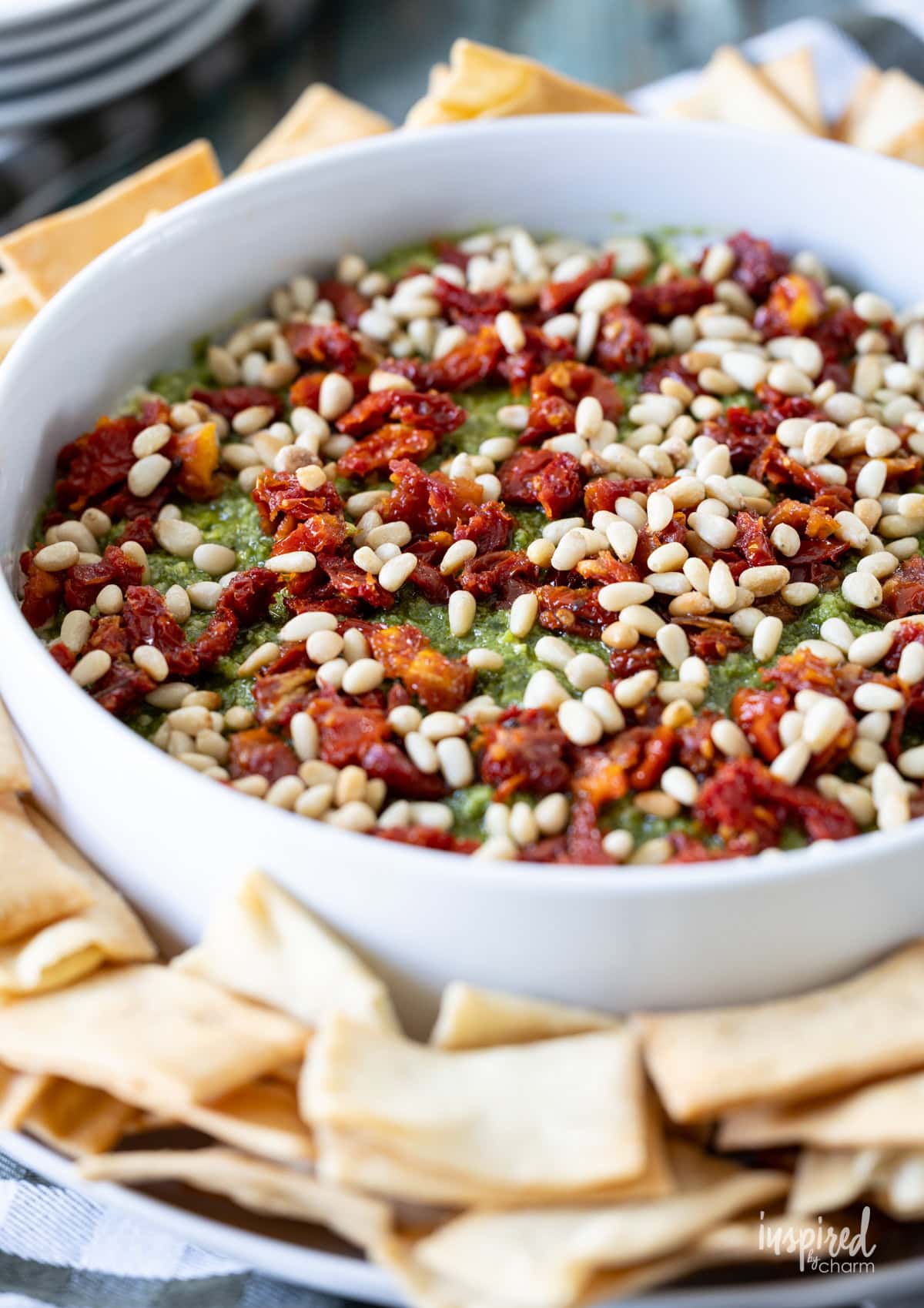 round dish filled with Pesto and Feta Layer Dip.