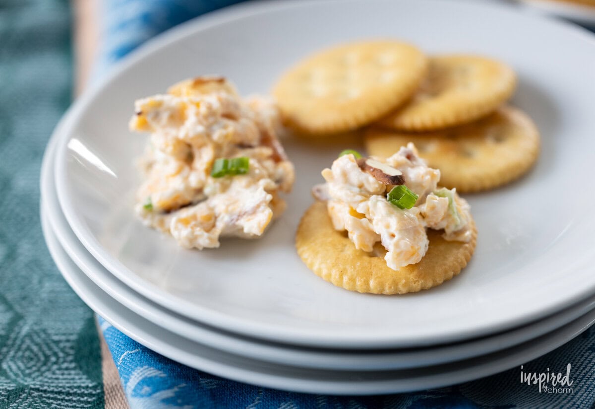 Neiman Marcus Dip served on crackers on a plate.