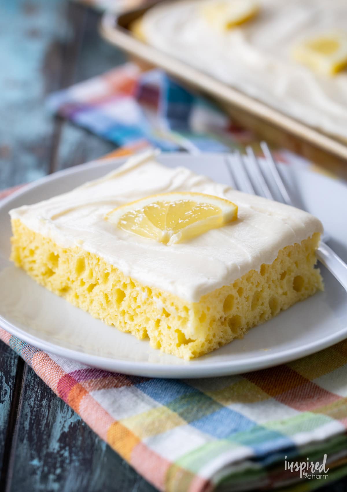 slice of lemon sheet cake on a plate.