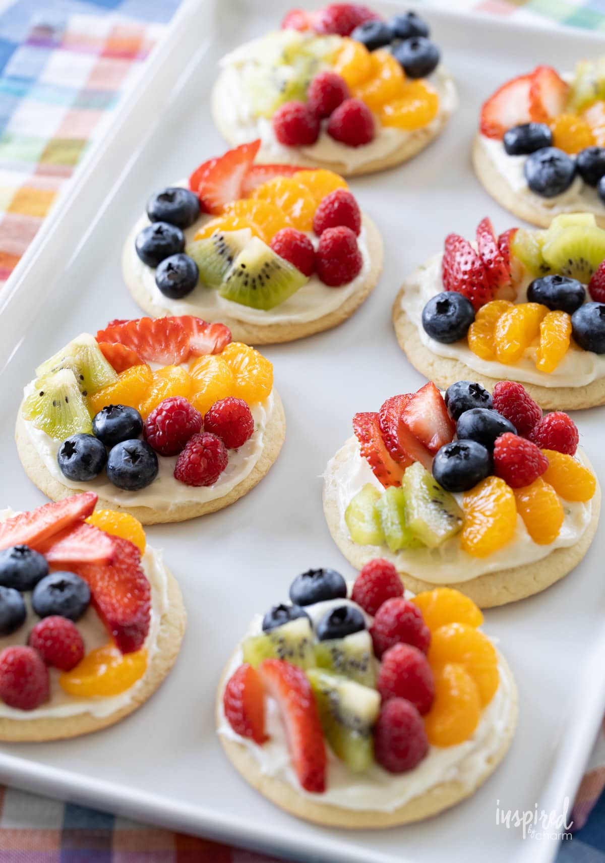 array of mini fruit pizzas on a platter. 