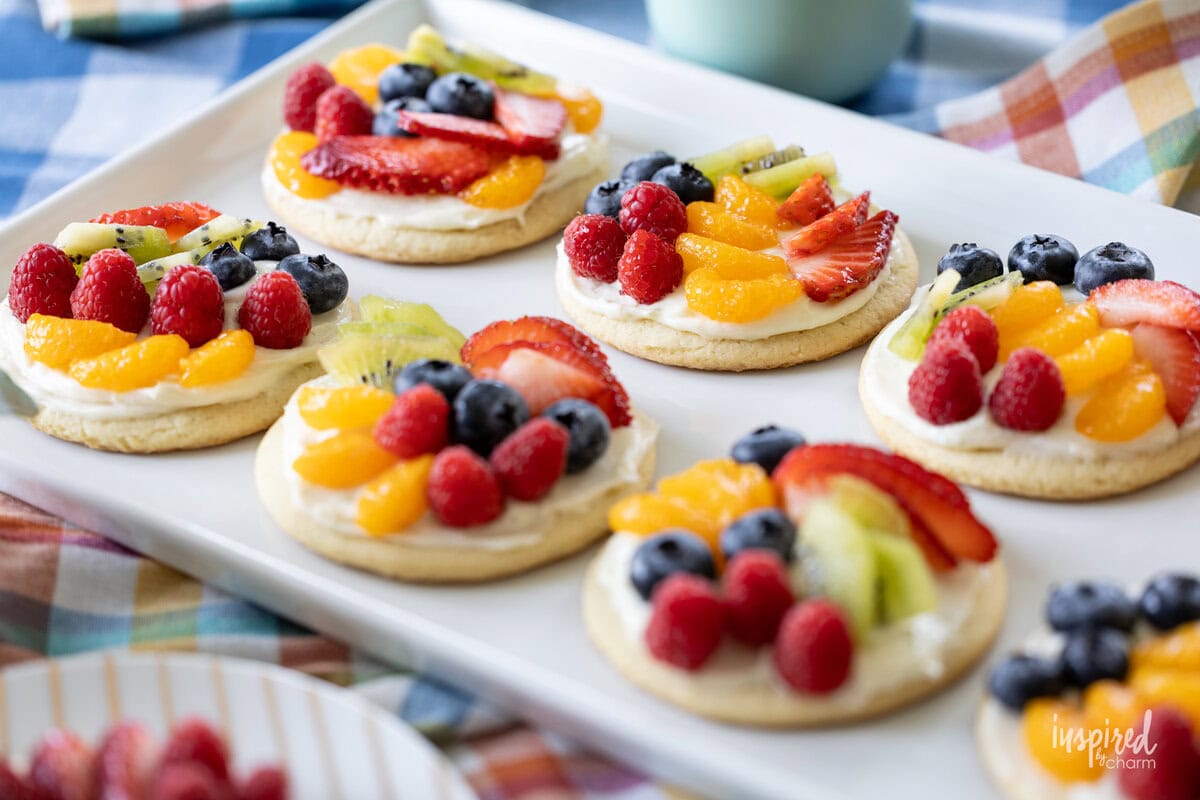 platter filled with mini fruit pizzas with a variety of fruit.