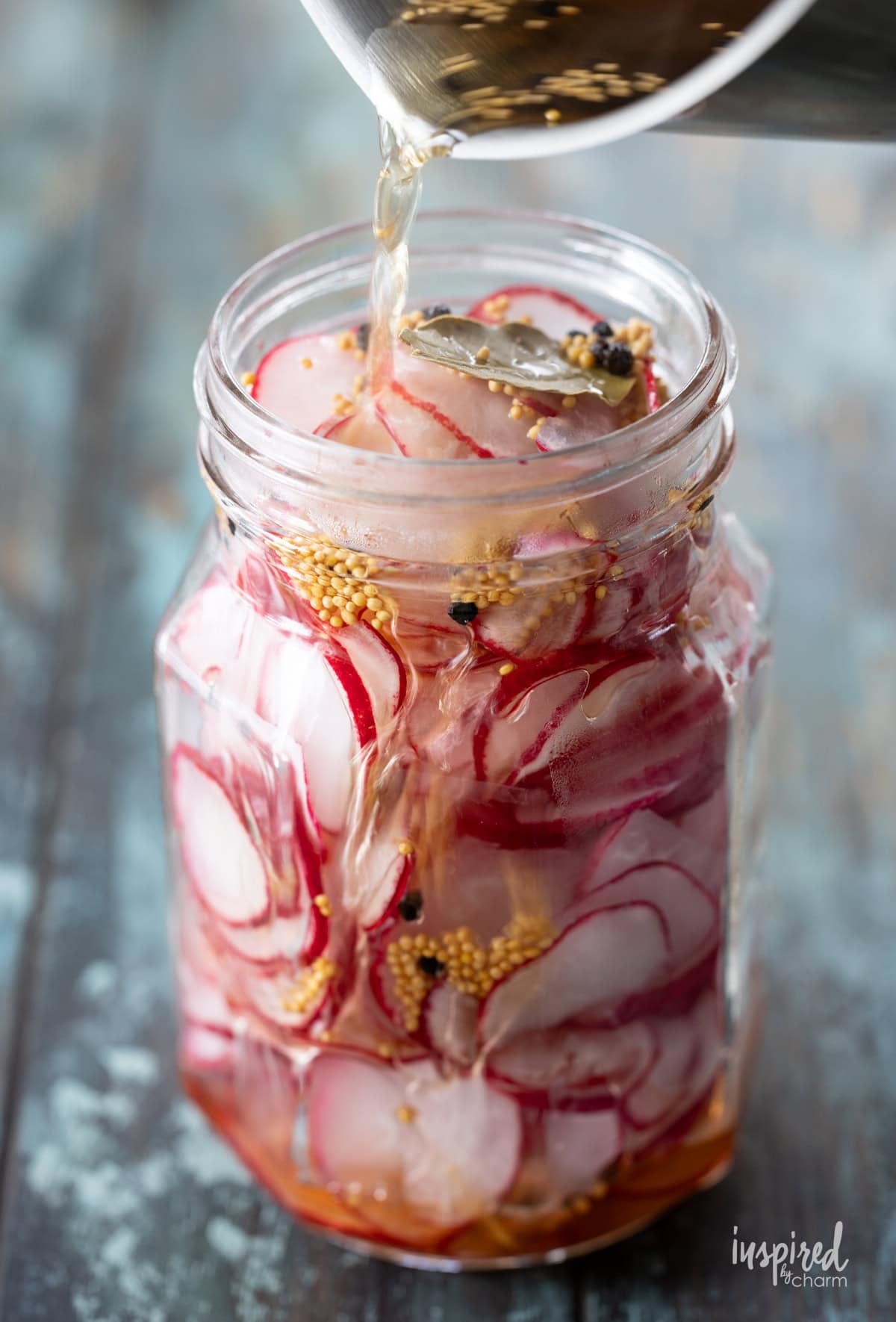 pot pouring brine into sliced radishes.