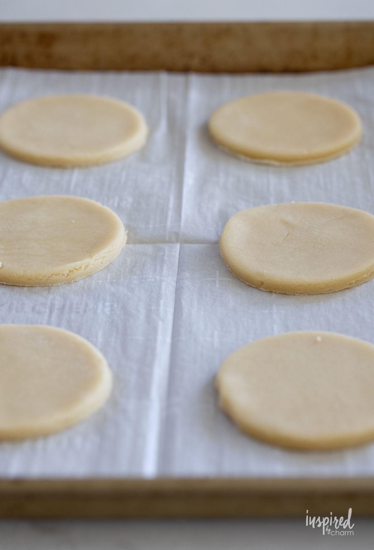 unbaked sugar cookies on a baking sheet. 