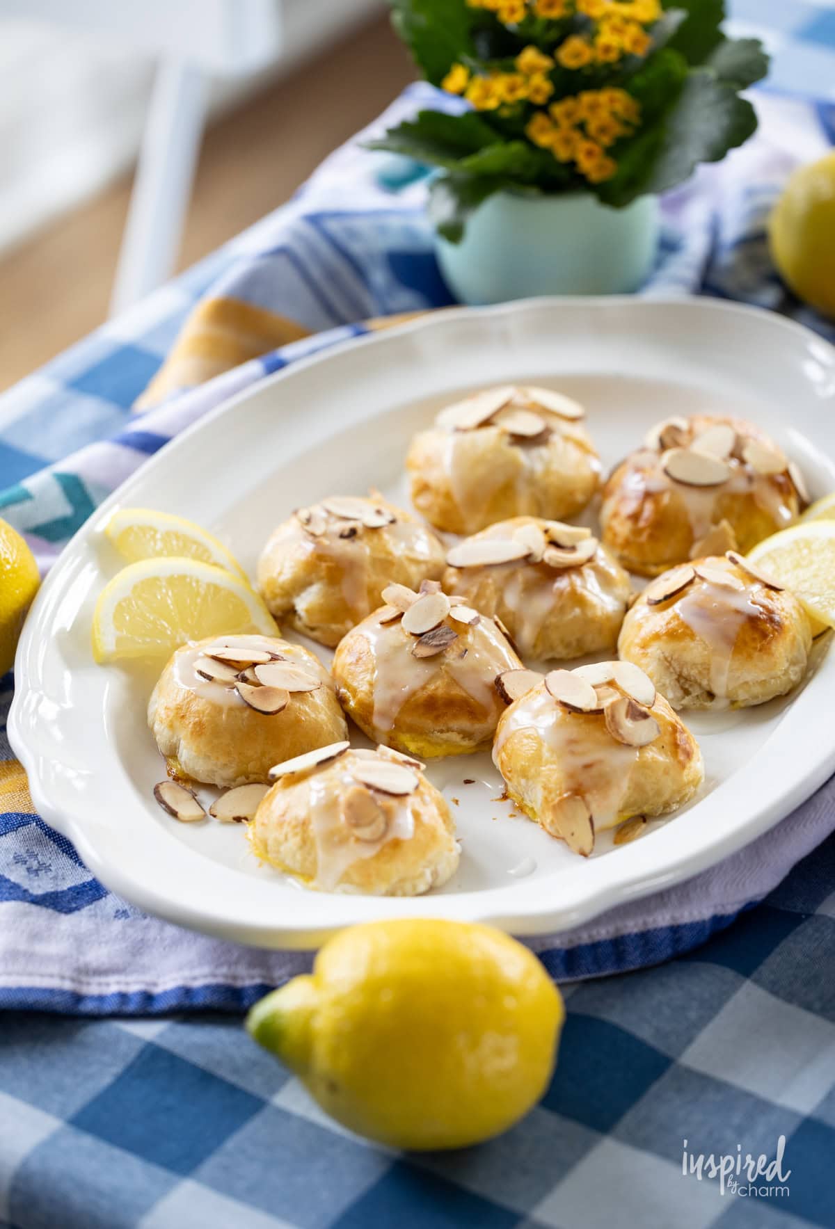 table with a plate of Lemon Almond Cream Cheese Puff Pastries.