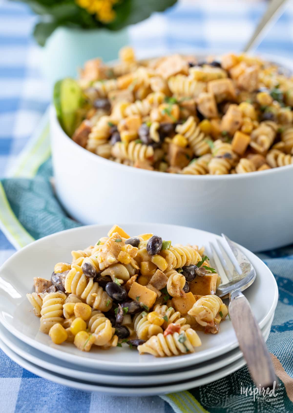 Southwest Chicken Pasta Salad in a large bowl and served on a small white plate. 