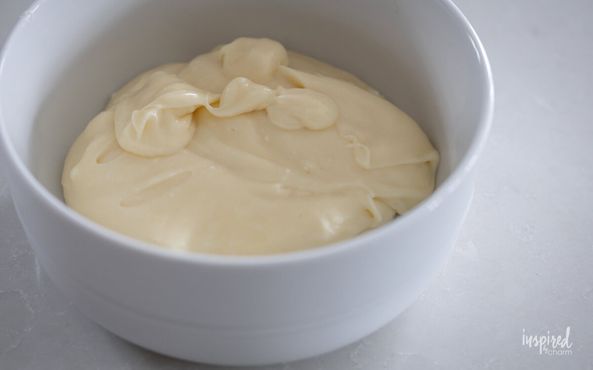 lemon curd and cream cheese filling a bowl.