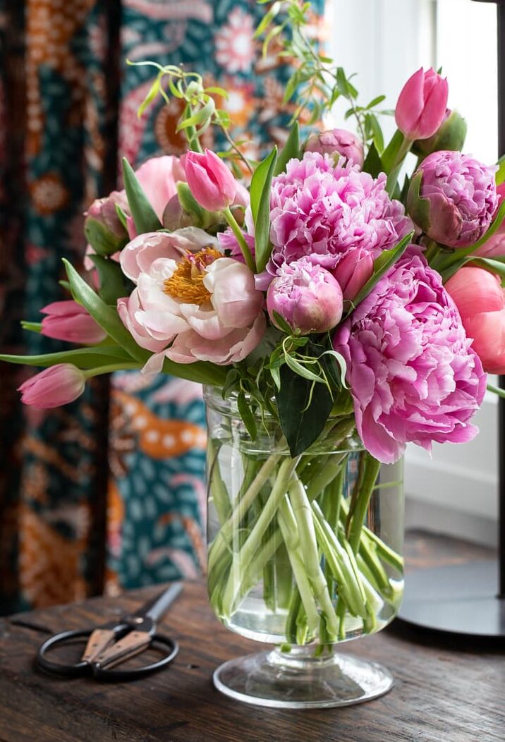 peony arrangement in glass vase.