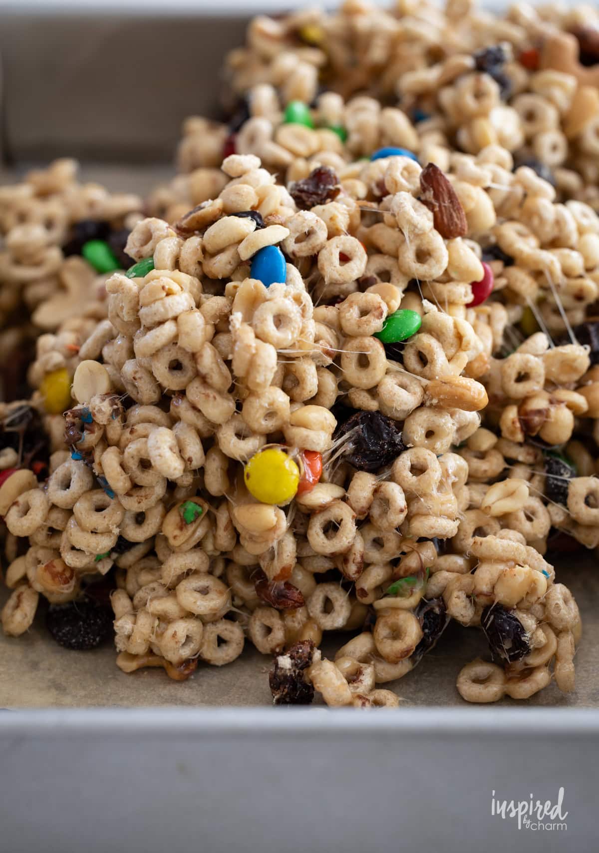 adding Trail Mix Bars ingredient into baking pan.