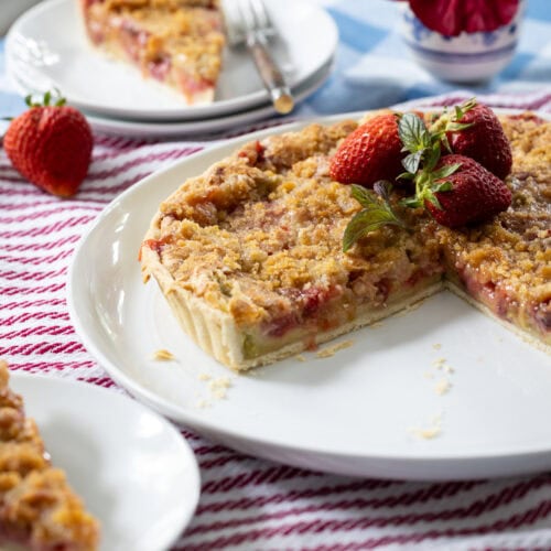 Strawberry Rhubarb Tart on platter and served on plates.