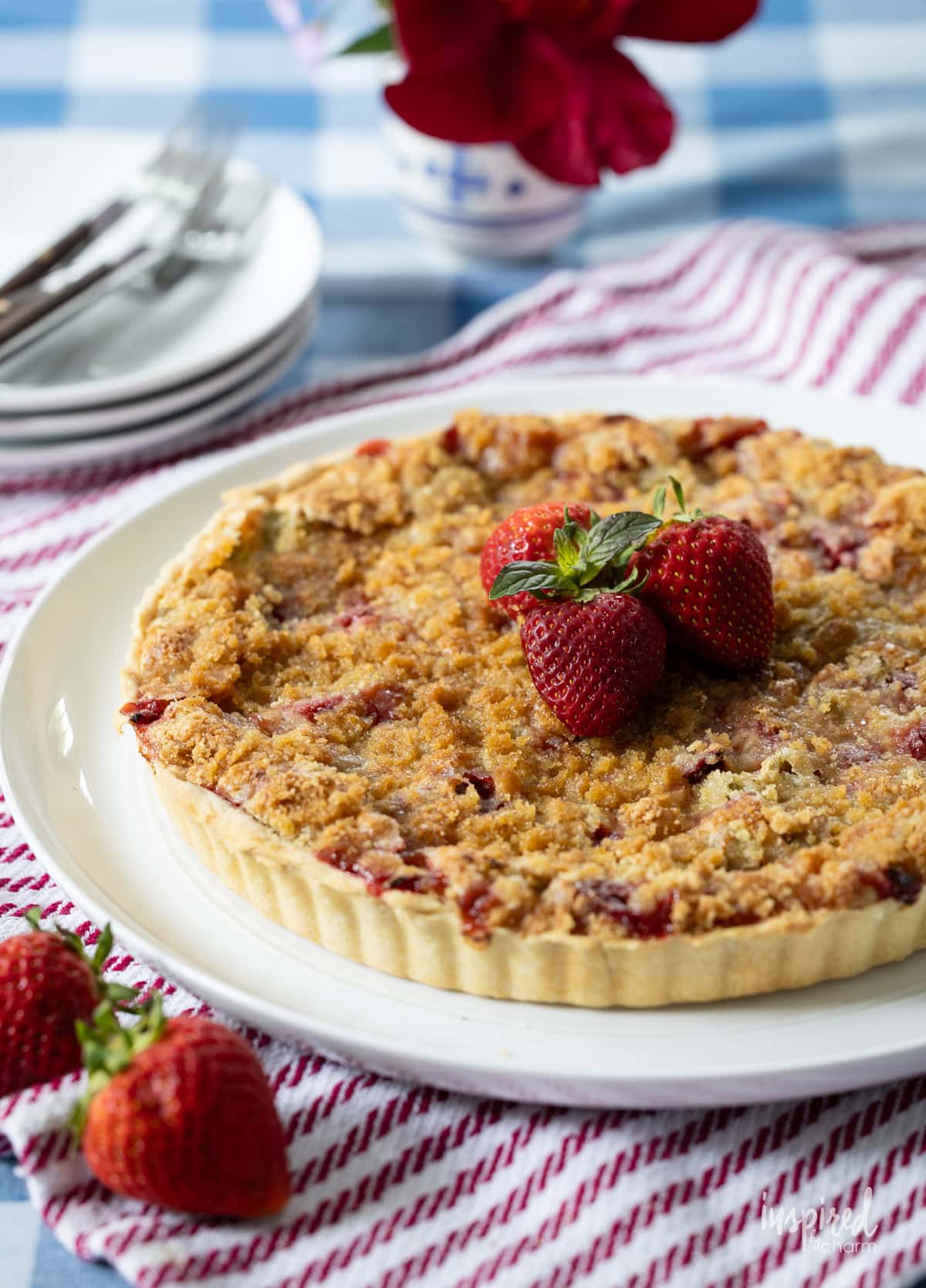 whole Strawberry Rhubarb Tart on a round platter.