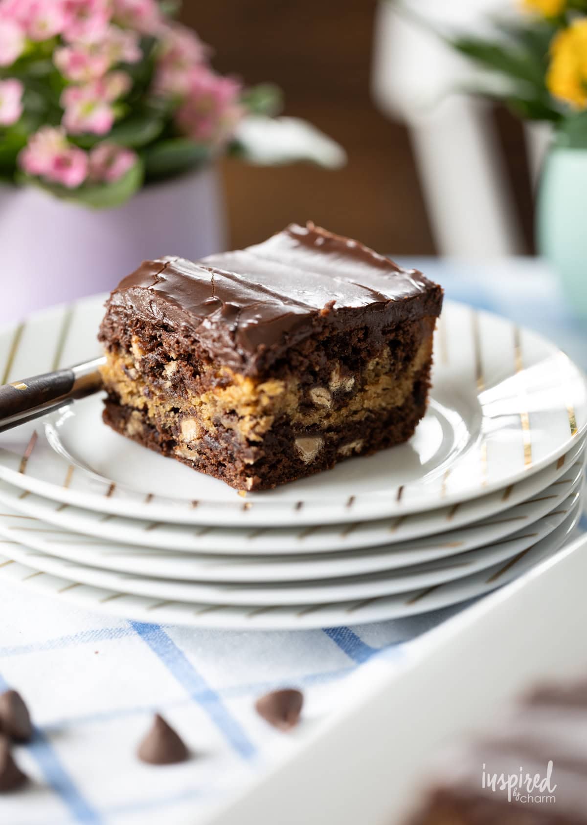 peanut butter fudge brownies on a stack of plates. 