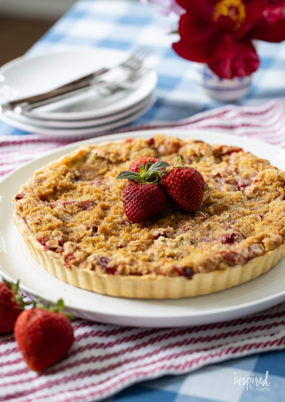 whole Strawberry Rhubarb Tart on large plate.