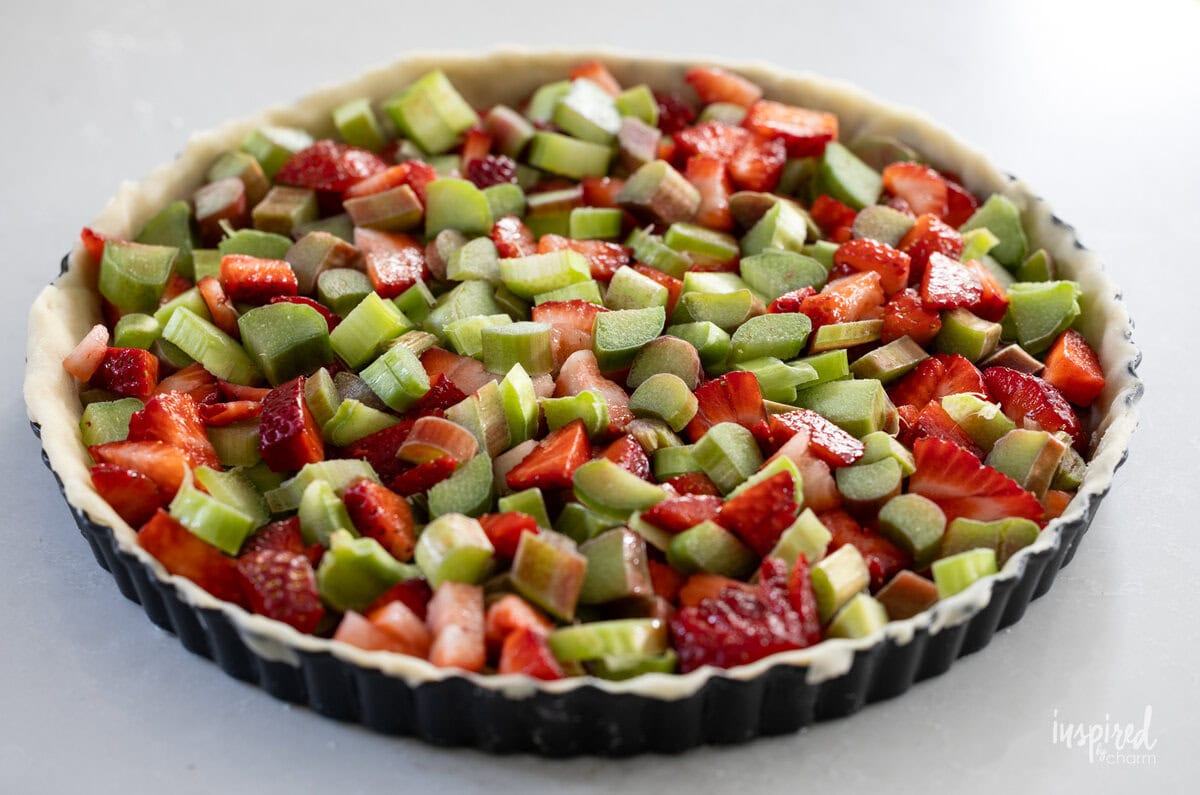 start shell filled with chopped rhubarb and strawberries.