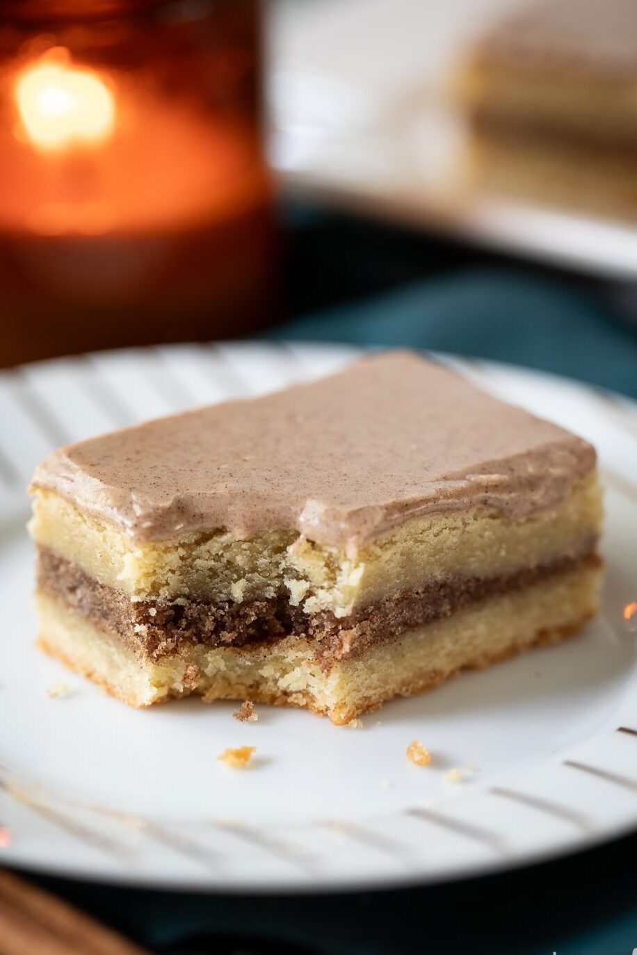 brown sugar cinnamon pop tart bar on a plate with a bite removed.