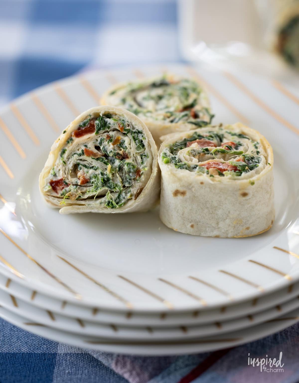 three Spinach Dip Roll-Ups on a plate.