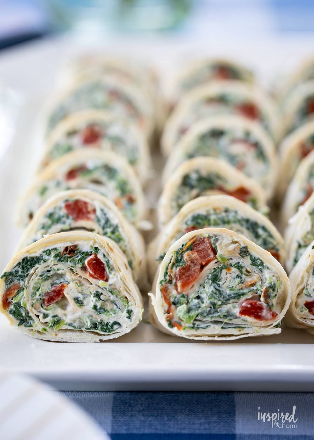 array of Spinach Dip Roll-Ups on a platter.