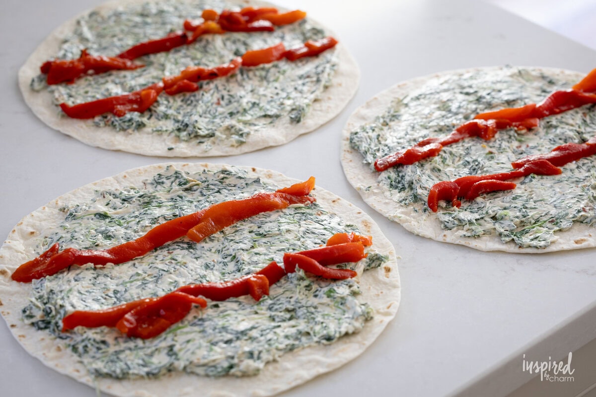 Spinach Dip Roll-Ups in process on kitchen counter.