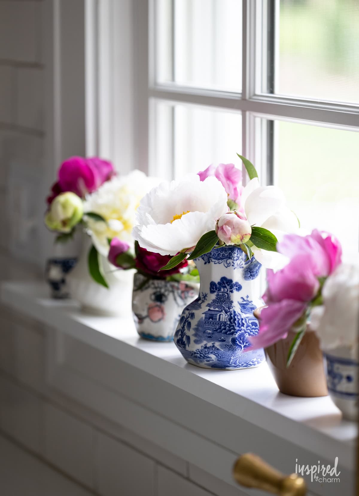 peonies decorated on a kitchen windowsill.