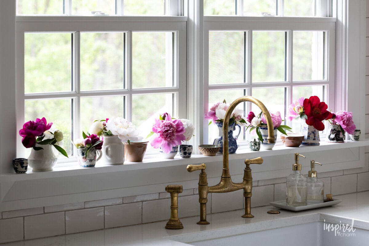 array of small pitchers filled with peonies. 