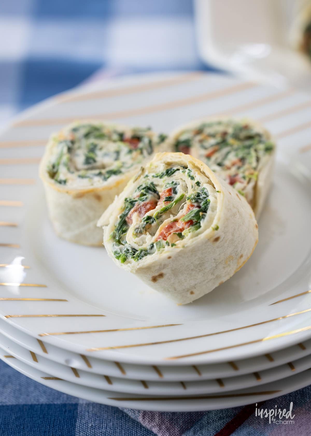 Three Spinach Dip Roll-Ups on a plate.