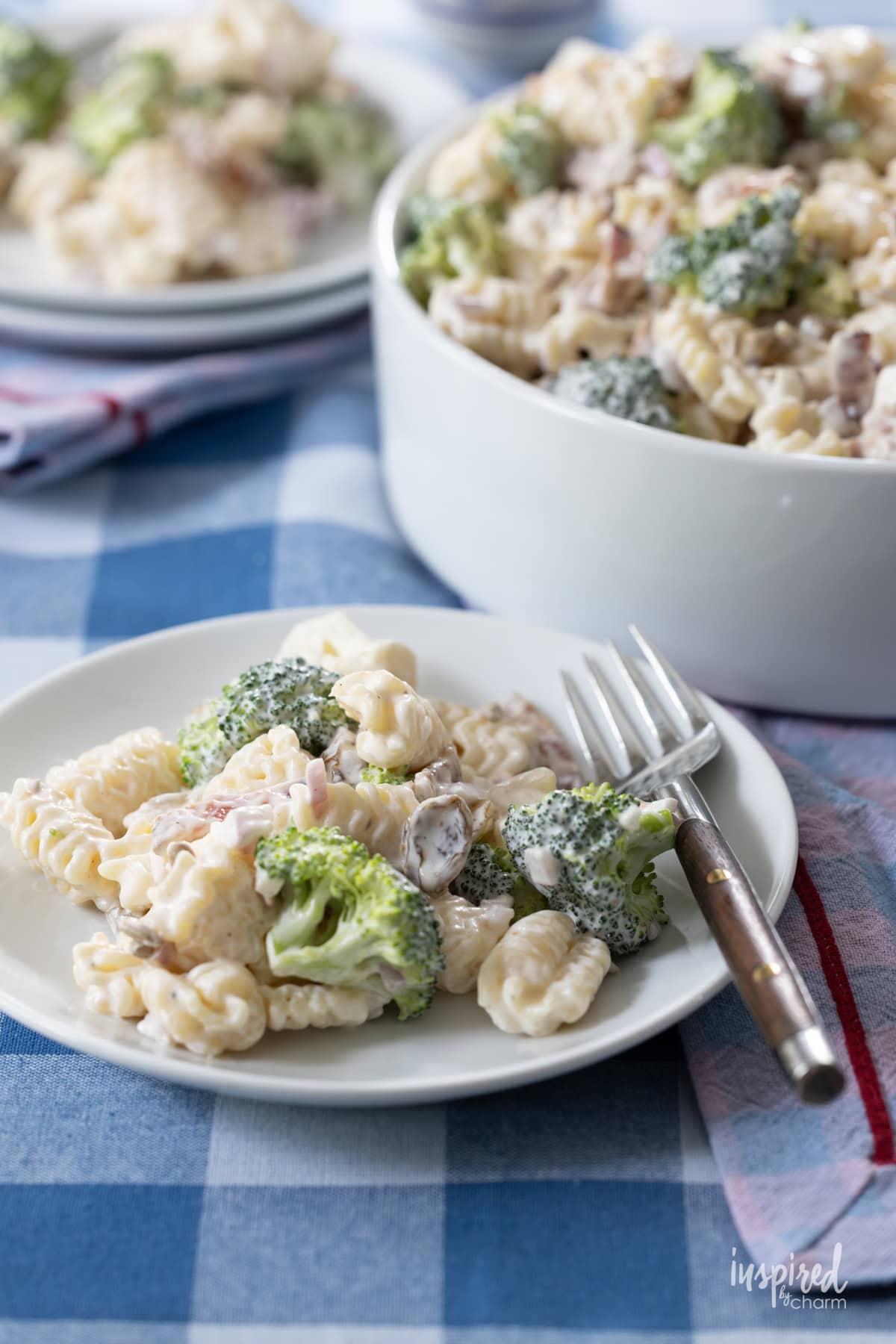 Broccoli Pasta Salad served on small plates with a fork.