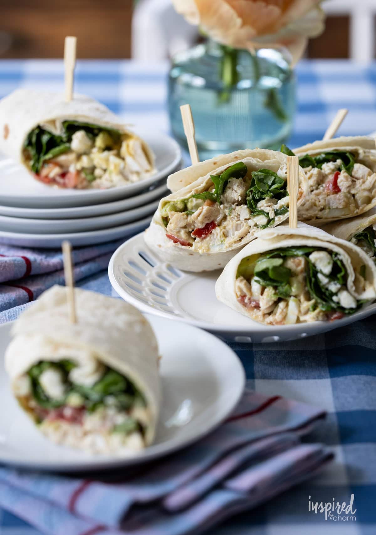 table with plates and napkins and Cobb Salad Wraps.